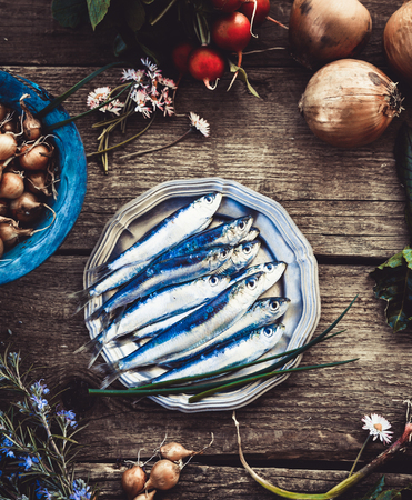 Fresh sardines. Fish with vegetables. Mediterranean fish on plateの写真素材