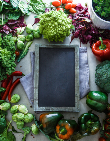 Fresh vegetables flatlay overhead frame.Blackboard with vegetables.. Food layout. Diet. Dieting planの写真素材