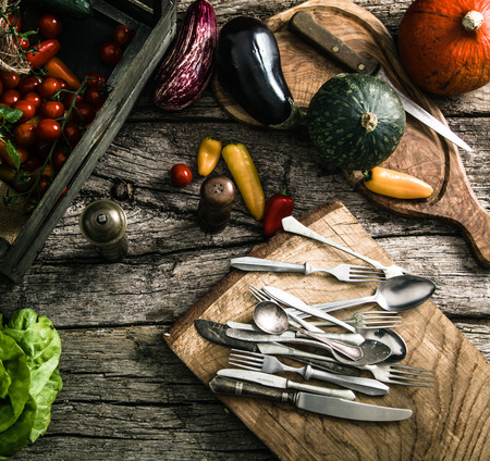Organic food. Organic vegetables on wood. Rustic cutlery on wood. . Rustic settingの写真素材