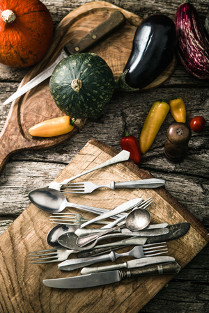 Organic food. Organic vegetables on wood. Rustic cutlery on wood. . Rustic settingの写真素材