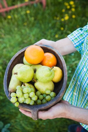 Fresh fruit. Farmer with bowl of fruit.s. Fruit basket.の写真素材