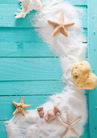 Summer background. Wooden background with white sand and seashells.Shells, starfish and sand. Holiday backgroundの写真素材