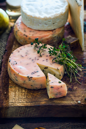 Cheese on wood. Types of cheese and herbs on woodの写真素材