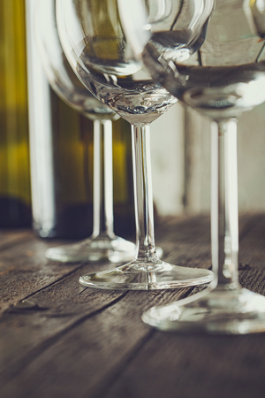 Wine. Empty wine glass. in wine cellar. Old white wine on wood.Arranged wine glassesの写真素材