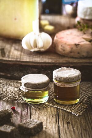 Honey on wood. Organic honey and cheese in vintage settingの写真素材