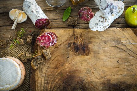 Cheese and Salami. Variety od cold cuts. Cheese on wood. Types of cheese and sausagesの写真素材