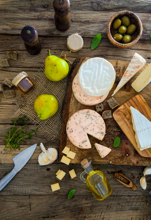 Cheese on wood. Types of cheese and herbs on woodの写真素材