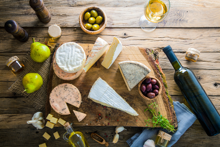 Cheese on wood. Types of cheese and herbs on woodの写真素材