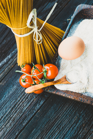 Italian cooking with whole wheat pasta and ingredientsの写真素材