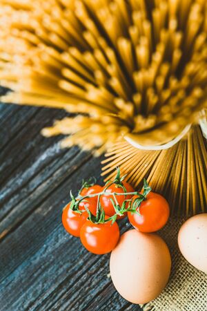 Italian cooking with whole wheat pasta and ingredientsの写真素材