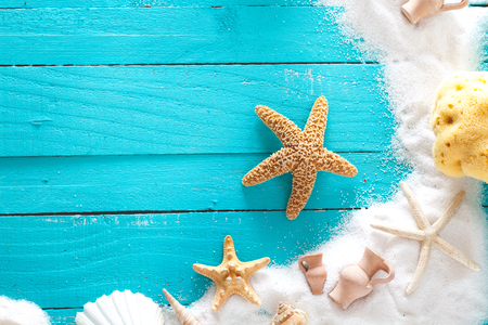 Summer background. Wooden background with white sand and seashells.Shells, starfish and sand. Holiday backgroundの写真素材
