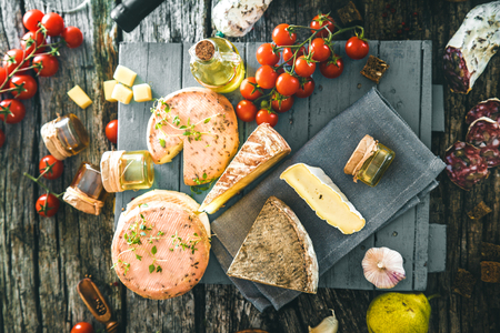 Cheese and Salami. Variety od cold cuts. Cheese on wood. Types of cheese and sausagesの写真素材