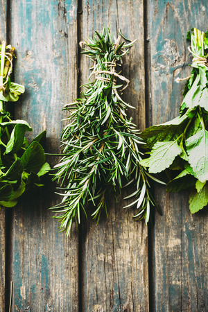 Fresh herbs. Melissa, rosemary and mint in rustic settingの写真素材