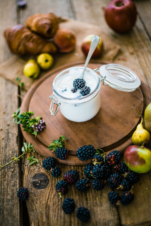 Breakfast food. Yogurt on table with fresh fruitの写真素材