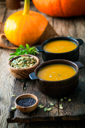 Pumpkin soup. Autumn dinner with healthy vegetable soup. Thankgsgiving tableの写真素材