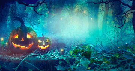 Halloween theme with pumpkins and dark forest. Scary Halloween design on tableの写真素材