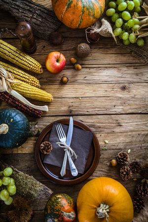 Thanksgiving dinner. Autumn fruit with plate and cutlery. Thanksgiving autumn backgroundの写真素材