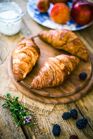 Breakfast food. Croissants on table with fresh fruitの写真素材