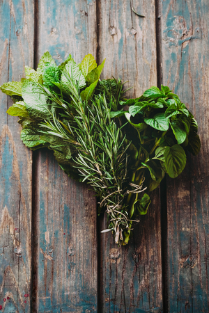 Fresh herbs. Melissa, rosemary and mint in rustic settingの写真素材