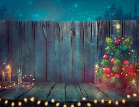 Christmas tree design. Wooden planks with Christmas lights and tree. Xmas decorationの写真素材
