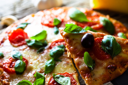 Pizza with cheese, tomatoes and basil. Rustic italian pizzaの写真素材