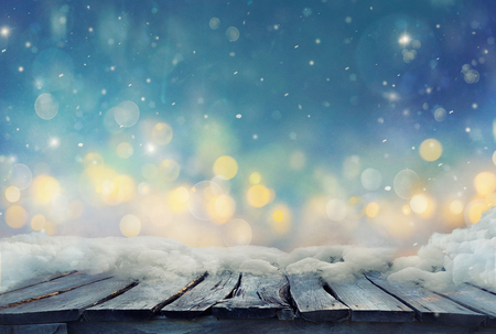 Winter design.  Christmas background with Frozen wooden table with bokeh. Snow and ice on wooden table with. Bokeh blurred backgroundの写真素材