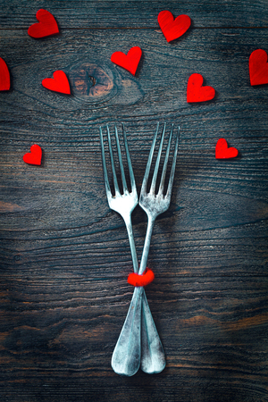 Restaurant menu. Valentines day dinner with table setting in rustic wood style with cutleryの写真素材