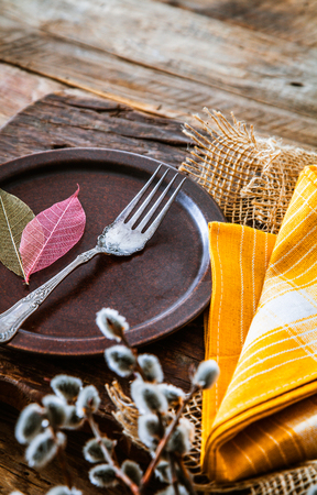 Spring table setting. Cutlery on wood. Fork in plateの写真素材