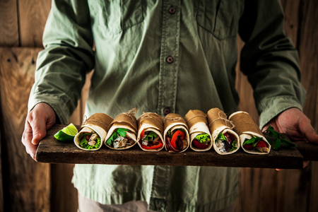 Man with snacks and dips. Tortilla mexican food. Party food. Chef with tapasの写真素材