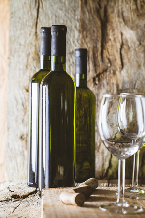 Wine. Glass of white wine in wine cellar. Old white wine on wood.の写真素材
