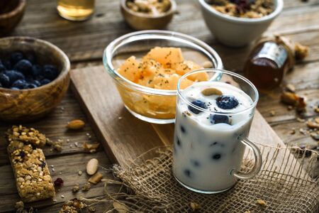 Healthy breakfast variety. Cereals with fruit. Yogurt with seedsの写真素材