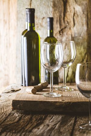 Wine. Glass of white wine in wine cellar. Old white wine on wood.の写真素材