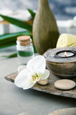 Spa and wellness. Natural setting with candle and orchid. Spa treatment.の写真素材