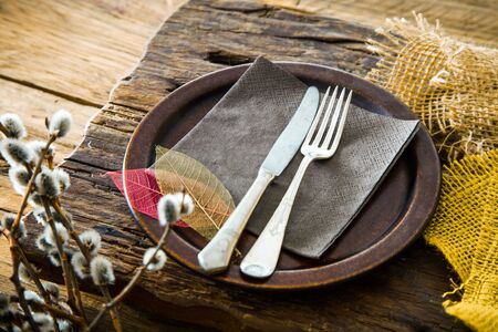 Spring table setting. Cutley on wood. Fork and knife in plate. Flatlay overhead shotの写真素材