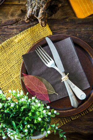 Spring table setting. Cutley on wood. Fork and knife in plate. Flatlay overhead shotの写真素材