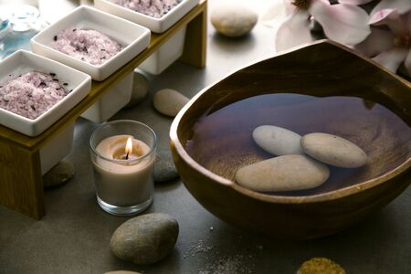 Spa and wellness. Natural massage stones  with magnolia flower .Spa treatmentの写真素材