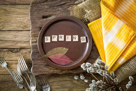 Spring table setting. Cutley on wood. Flatlay overhead shot. Wooden letters with spring textの写真素材