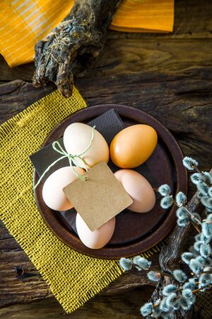 Easter table setting. Fresh eggs on plate. Spring table. Flatlay overhead shotの写真素材