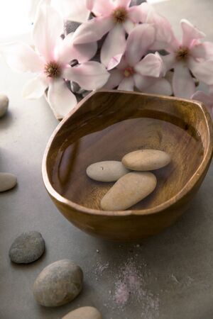 Spa and wellness. Natural massage stones , silkworm cocoon with magnolia flower .Spa treatmentの写真素材
