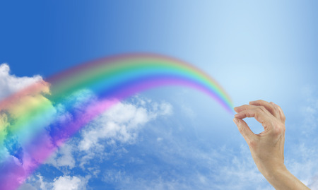 Creating a beautiful rainbow on blue sky backgroundの写真素材
