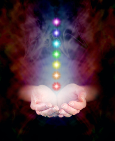 Seven Chakras floating in Healing Hands