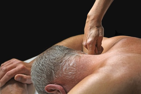 Therapist applying pressure to client\'s neck