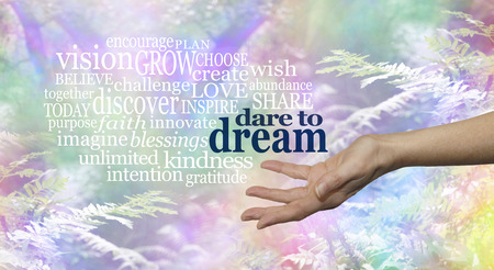 Dare to Dream word cloud - Female hand outstretched palm up on a rainbow woodland background and the words DARE TO DREAM floating above surrounded by a relevant word cloudの写真素材