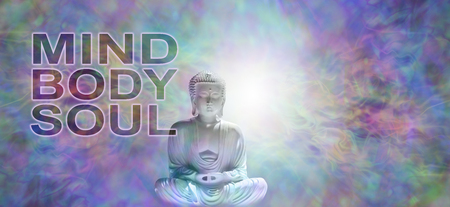 Mind Body Soul Buddha Banner - Buddha in meditative lotus position with white light behind head on a multicolored energy field background  and the words MIND BODY SOULの写真素材