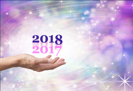 Leave 2017 behind for 2018 - female hand open palm outstretched with a pale pink 2017 and a navy...
