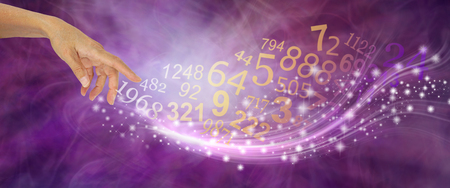 Numerology is far more than just NUMBERS - female hand appearing to create a swish of sparkles and a flow of random numbers on a pink purple energy formation backgroundの写真素材