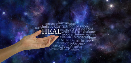 Heal Word Tag Cloud - female hand gesturing towards the word HEAL surrounded by a relevant word tag cloud on a dark blue deep space night sky backgroundの写真素材