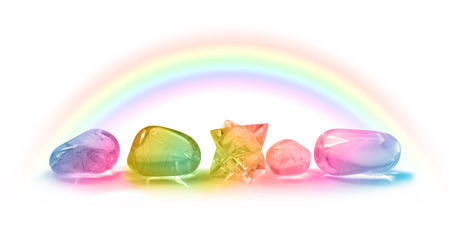 Five Beautiful Rainbow Healing Crystals - Four rainbow colored healing crystals and a merkabah laid in a row on a white background with a rainbow arcing above from left to rightの写真素材