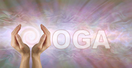 Come and Experience Yoga Energy - Female using both hands to make the Y in the word YOGA on a pink grey energy formation background with a spiral behind the Yの写真素材