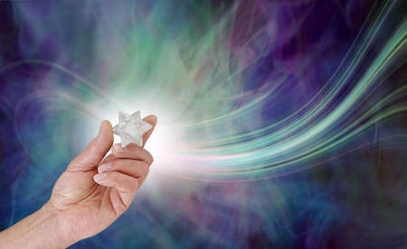 The beautiful energy a Merkabah emits - male handing holding a white quartz Merkabah polished...